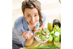 Image Woman eating fresh vegetable salad